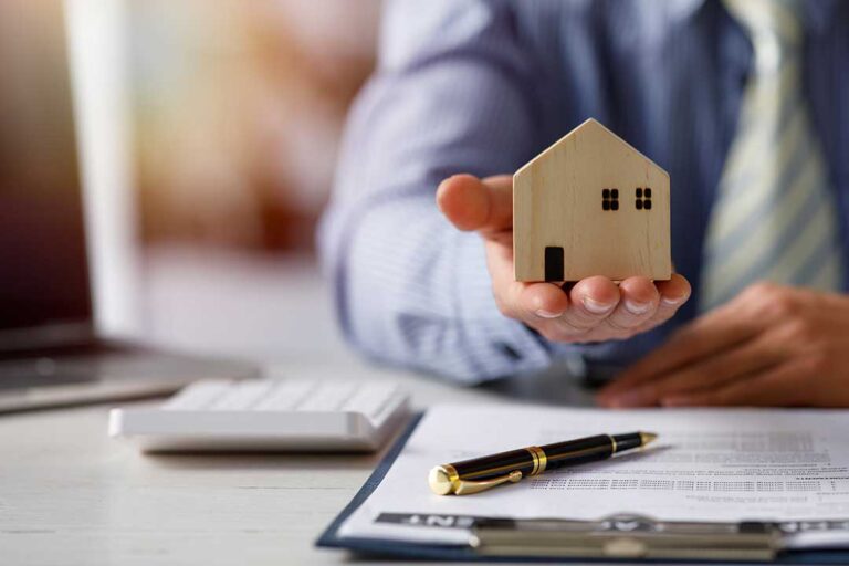 Buyers examine a home interior while checking a ceiling stain, electrical outlet, and plumbing cabinet.